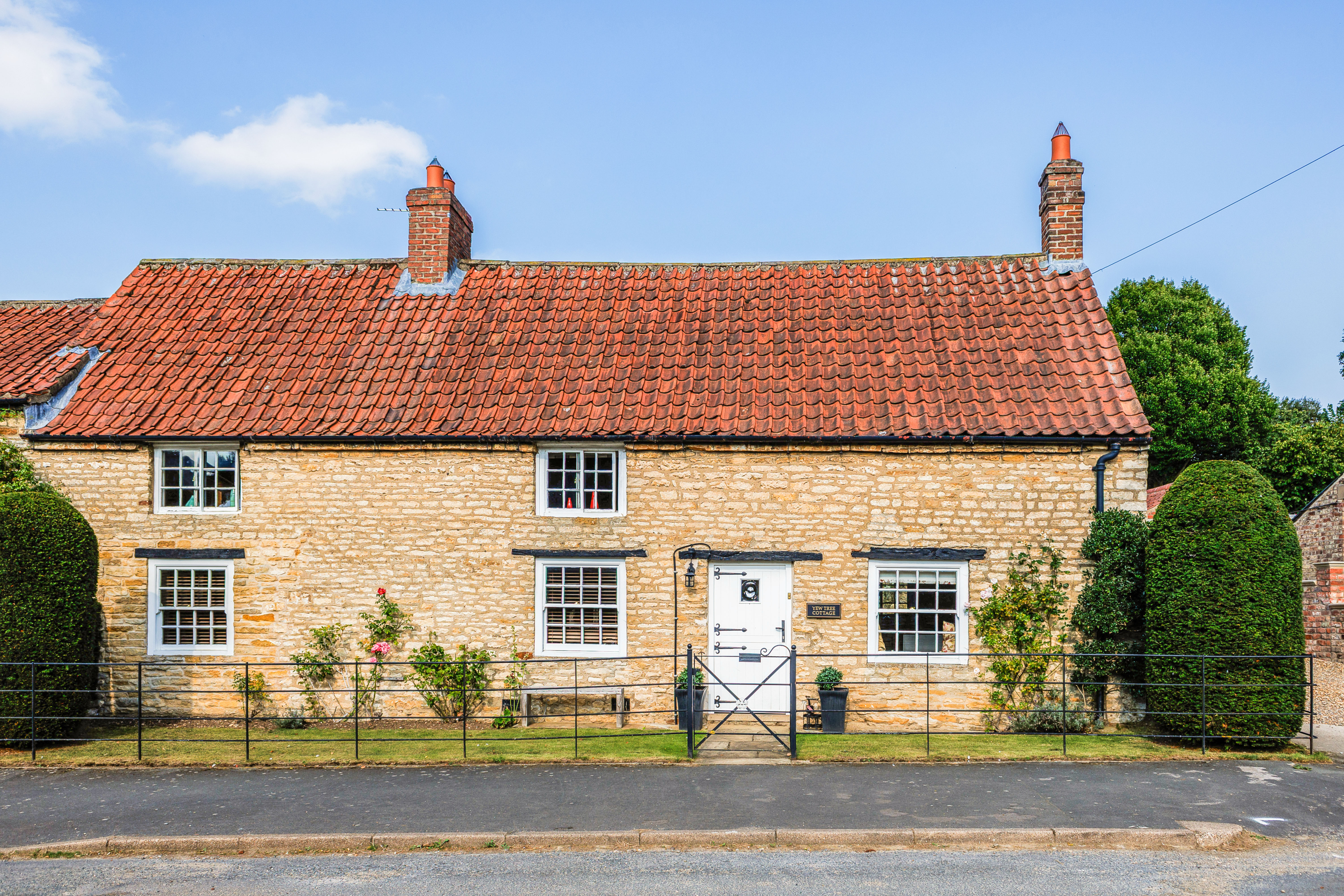 Exterior of Yew Tree Cottage, a Grade II Listed stone cottage in Westow village, North Yorkshire